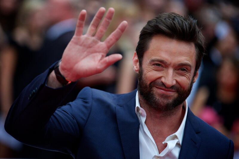 Australian actor Hugh Jackman poses for pictures on the red carpet as he arrives for the UK premier of the film 'The Wolverine' in London on July 16, 2013. AFP PHOTO/ANDREW COWIE
 *** Local Caption ***  561338-01-08.jpg