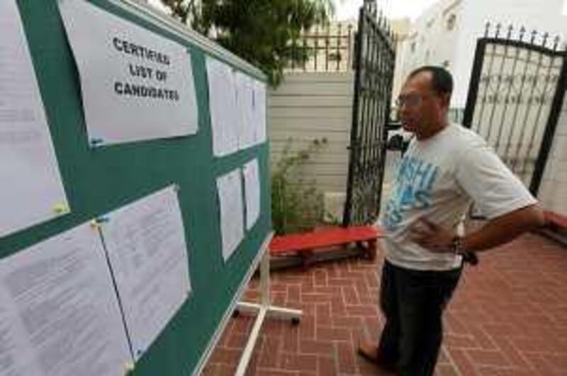 United Arab Emirates - Abu Dhabi - April 10 - 2010 : Glerry M. Balagosa, from philippine, check the list of candidates after voting at overseas absentee voters in the Philippine Embassy. ( Jaime Puebla / The National )