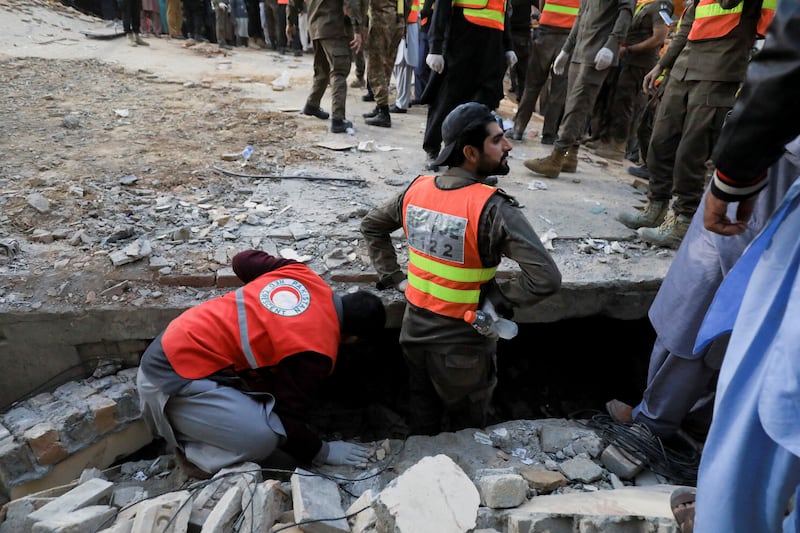 Rescue workers search the rubble in Peshawar. Reuters