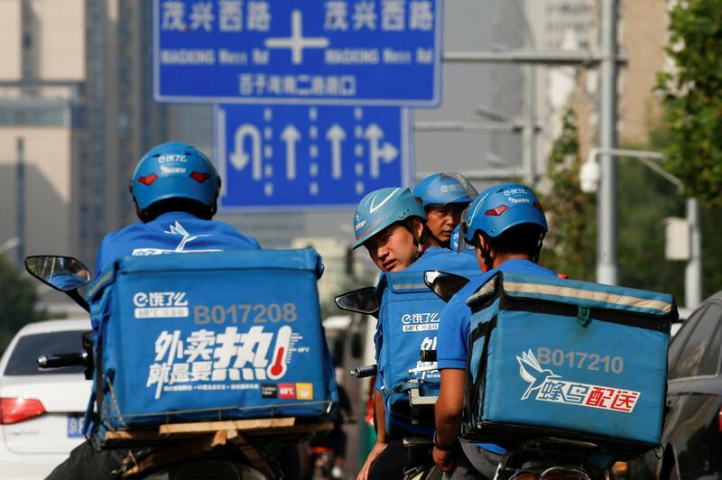 FILE PHOTO - Drivers of the food delivery service Ele.me prepare to start their morning shift after an internal security check in Beijing, China, September 21, 2017. REUTERS/Thomas Peter/File Photo