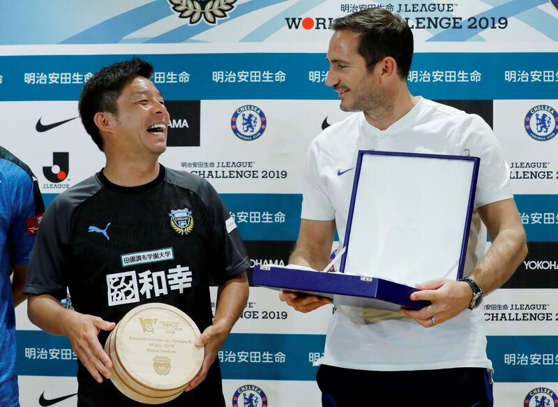 Chelsea manager Frank Lampard exchanges souvenirs with Kawasaki Frontale manager Toru Oniki. Reuters
