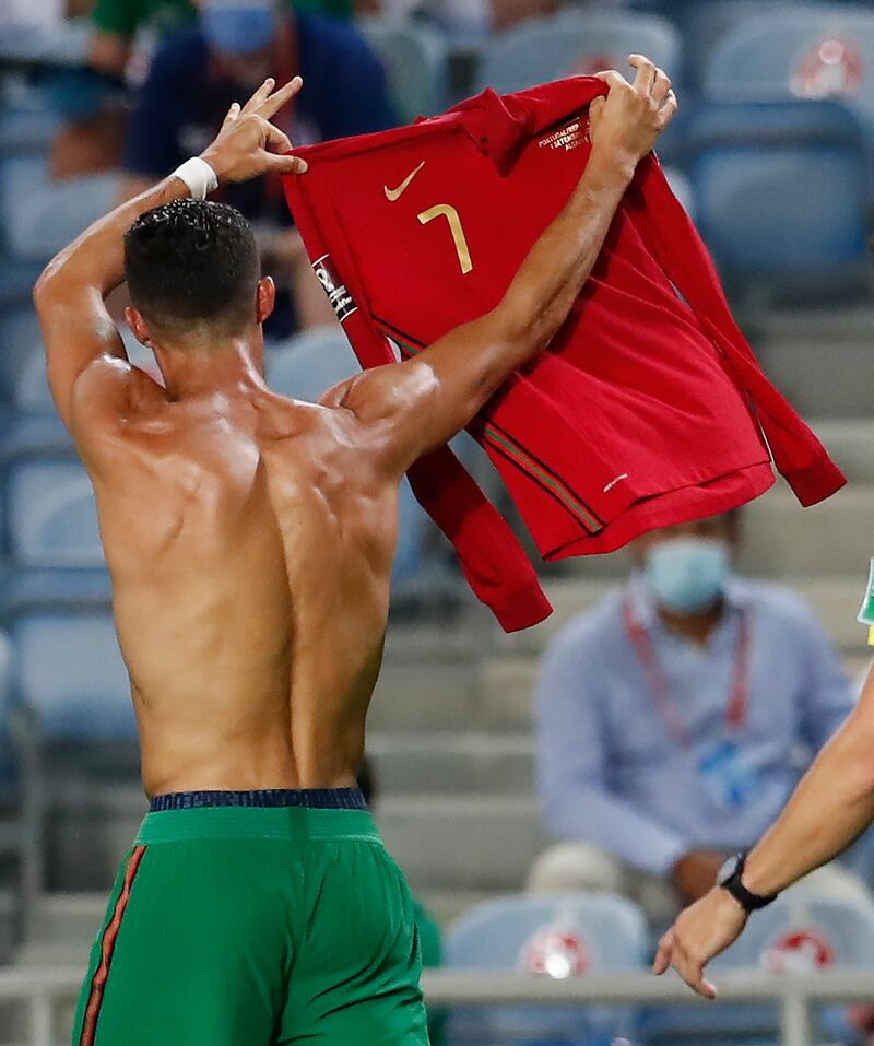 Portugal's Cristiano Ronaldo holds up his shirt as he celebrates after scoring his side's second goal. AP