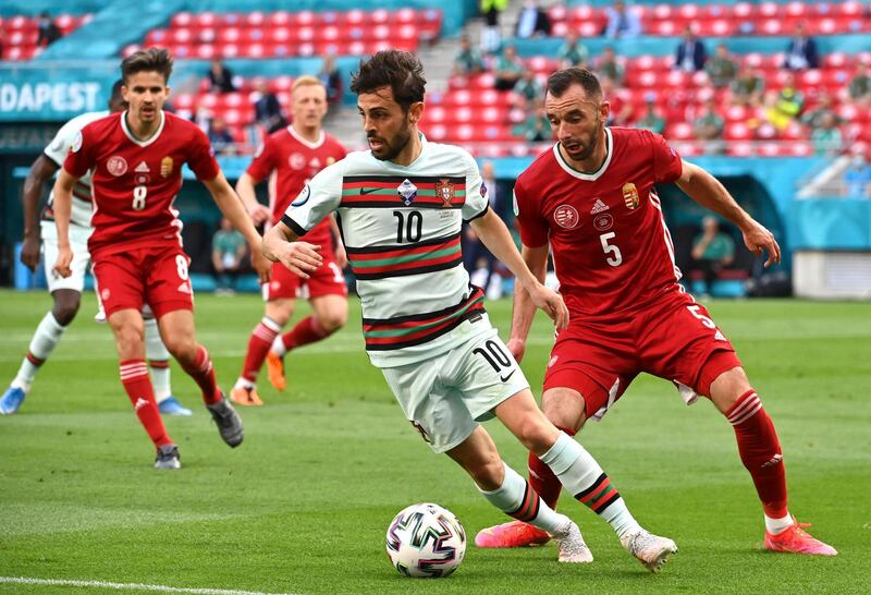 Portugal's Bernardo Silva under pressure from Attila Fiola of Hungary. PA