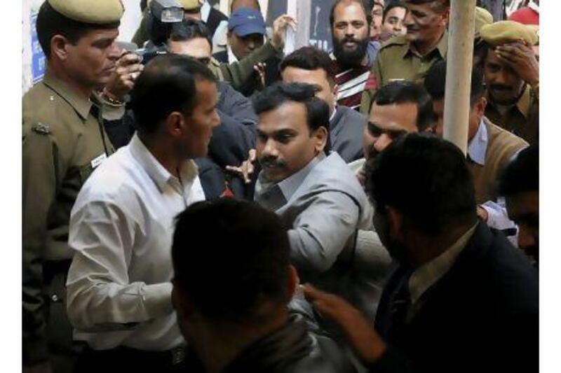 India's former telecommunications minister, Andimuthu Raja, centre, is produced at a court in New Delhi, India, yesterday. Federal agents arrested Mr Raja and two other officials on Wednesday in an investigation into a scandal that allegedly cost the government billions of dollars.