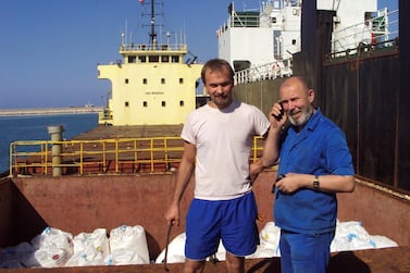 Boris Prokoshev, right, captain of the Rhosus, and boatswain Boris Musinchak pose next to a freight hold loaded with ammonium nitrate in the port of Beirut in 2014. Boris Musinchak / Reuters