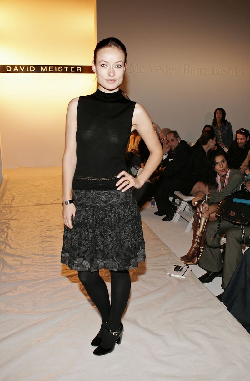 Olivia Wilde goes all black in dress, skirt, tights and shoes at the David Meister fall 2006 show in Culver City, California, on March 26, 2006.