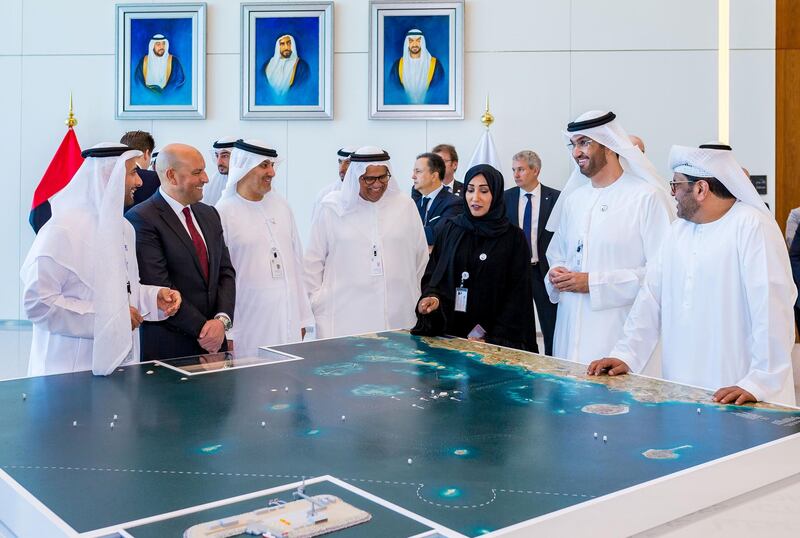 Dr. Sultan Ahmed Al Jaber, UAE Minister of State and ADNOC Group CEO, looks at the model after ADNOC signs AED 5 billion contract to establish artificial islands in the Gasha offshore concession. Courtsey: Adnoc