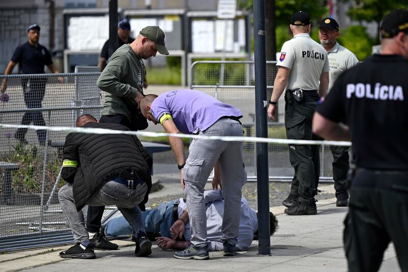 Police arrest a man after the shooting. AP