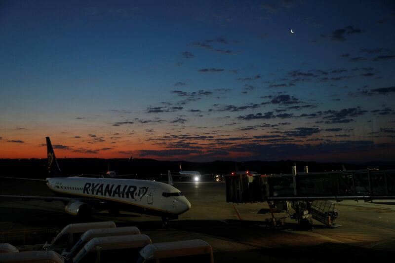 The moon is seen over a Ryanair plane at the Adolfo Suarez Madrid Barajas airport in Madrid, Spain. Reuters