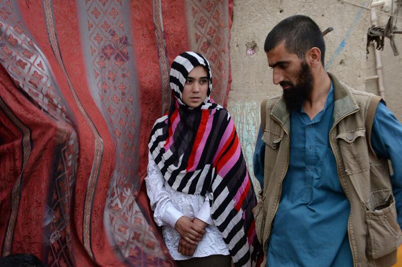 Aziza Rahimzada, who has been nominated for the International Children’s Peace Prize, speaks with her brother Bahram Rahimzada at her temporary home at a refugee camp in Kabul.