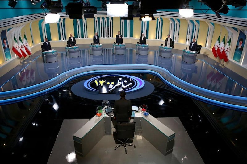 The candidates face a moderator in the television studio in Tehran. EPA
