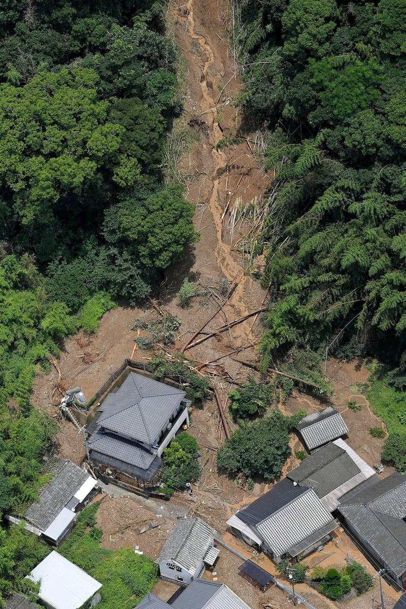 This aerial view shows the site of a mudslide caused by heavy rain in Ashikita town, Kumamoto prefecture. Kyodo News via AP