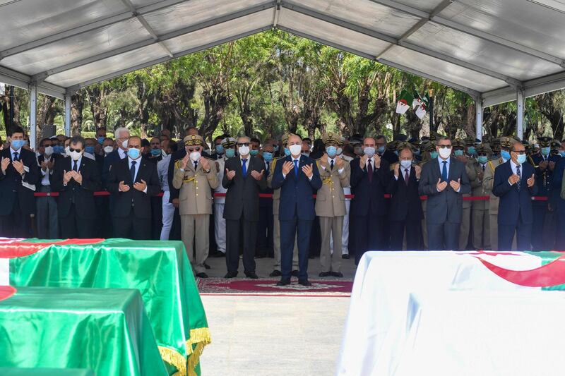 Algeria's President Abdelmajid Tebboune prays during a ceremony to lay to rest the remains of 24 resistance fighters, returned from Paris. AFP