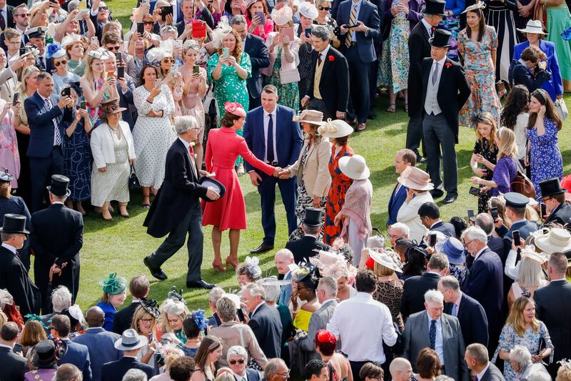 Catherine, Duchess of Cambridge, is surrounded by onlookers as she attends the queen's garden party at Buckingham Palace on  Wednesday. Getty