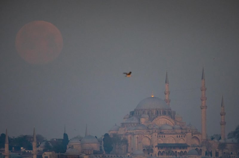 A full pink supermoon sets over the famous Suleymaniye Mosque in Istanbul, Turkey. Getty Images