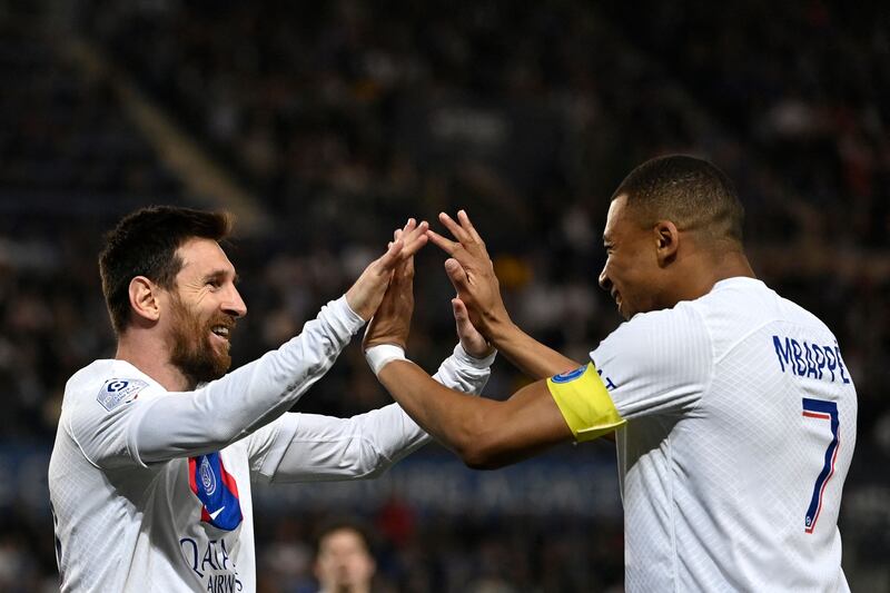 Lionel Messi celebrates with Kylian Mbappe after for PSG against Strasbourg. AFP
