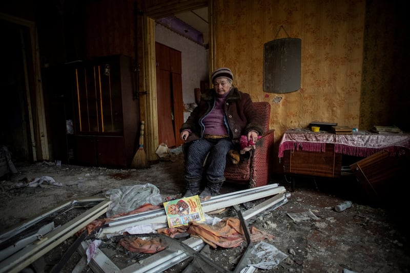 Natalia, 67, sits inside her house that was damaged in a Russian military strike, in Kramatorsk, Ukraine. Reuters