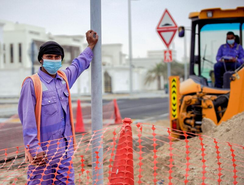 Abu Dhabi, United Arab Emirates, January 3, 2021.  Road workers on a chilly and hazy morning at Khalifa City.
Victor Besa/The National
Section:  NA/Weather