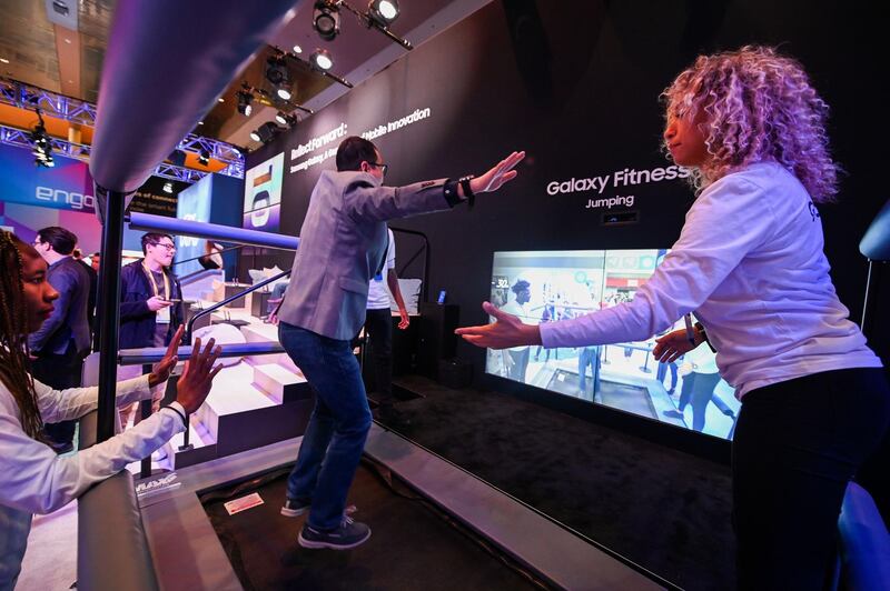 An attendee plays the Samsung Galaxy jumping fitness game. AFP