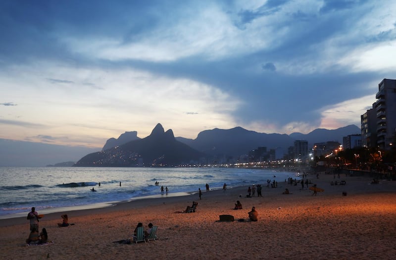 People gather on Ipanema beach at sunset in Rio de Janeiro, Brazil. Getty Images