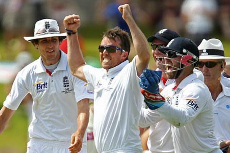 England's Graeme Swann celebrates with his team mates after dismissing Marcus North.
