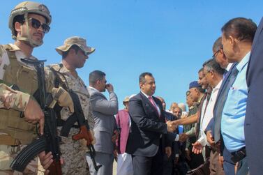 Yemen's Prime Minister Maeen Abdulmalik Saeed greets officials after arriving at Aden airport on November 18, 2019. AFP