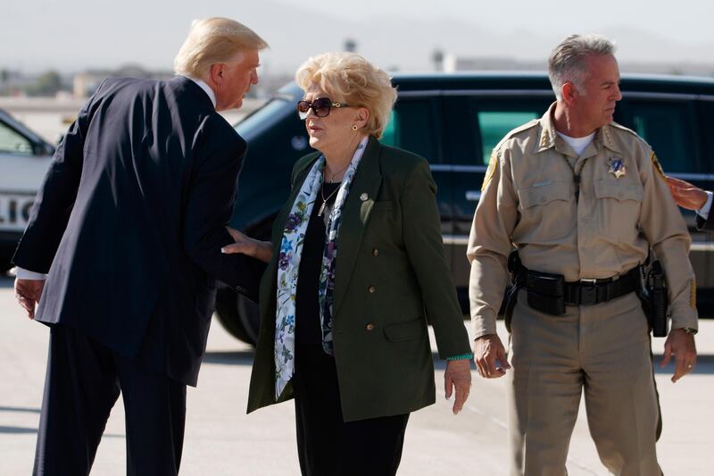 President Donald Trump talks with Las Vegas Mayor Carolyn Goodman and Clark County Sheriff Joseph Lombardo after arriving at Las Vegas McCarran International Airport to meet with victims and first responders of the mass shooting. Evan Vucci / AP Photo