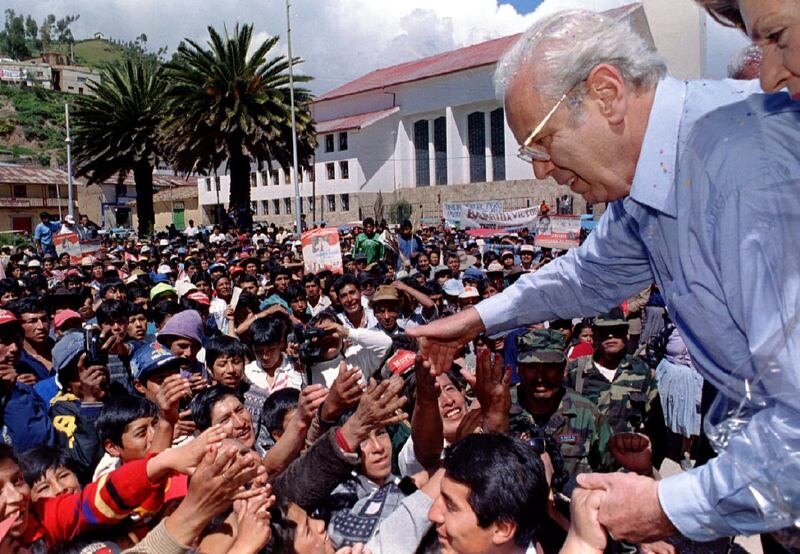 Mr de Cuellar greets supporters in Sicuani, after giving a public speech during a campaign rally in the Andes, Peru, in 1995. Reuters