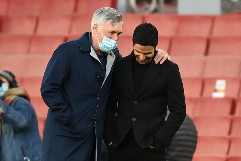 Everton coach Carlo Ancelotti and Arsenal's Mikel Arteta chat  ahead of the match. AFP