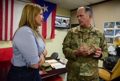 Canovanas Mayor Lorna Soto, left, and adjutant general of the National Guard Jose Reyes carry out a meeting at the Municipal Emergency Management headquarters, hours before the passing of tropical storm Dorian, in Canovanas, Puerto Rico, Wednesday, Aug. 28, 2019. Although Puerto Rico remains under hurricane surveillance according to the National Hurricane Center, Puerto Ricans did not skimp on preparing after having lived through the devastation of Hurricane Maria in 2017. (AP Photo/Carlos Giusti)
