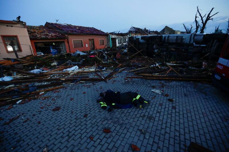 A member of the emergency services rests amid the debris from a tornado that struck the village of Moravska Nova Ves in the Czech Republic. Reuters