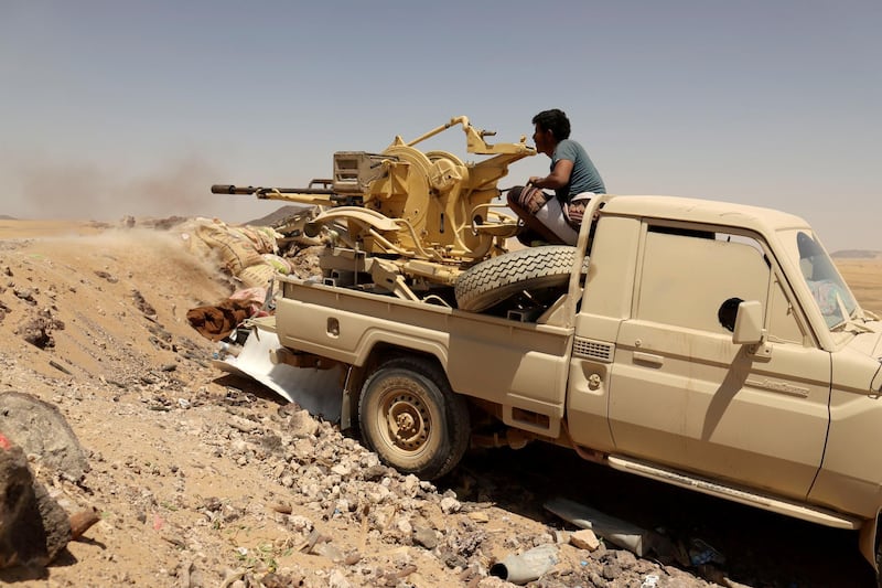 FILE PHOTO: A Yemeni government fighter fires a vehicle-mounted weapon at a frontline position during fighting against Houthi fighters in Marib, Yemen March 28, 2021. Picture taken March 28, 2021. REUTERS/Ali Owidha/File Photo