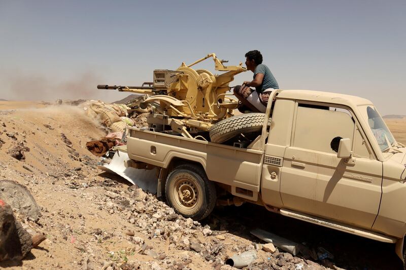 FILE PHOTO: A Yemeni government fighter fires a vehicle-mounted weapon at a frontline position during fighting against Houthi fighters in Marib, Yemen March 28, 2021. Picture taken March 28, 2021. REUTERS/Ali Owidha/File Photo