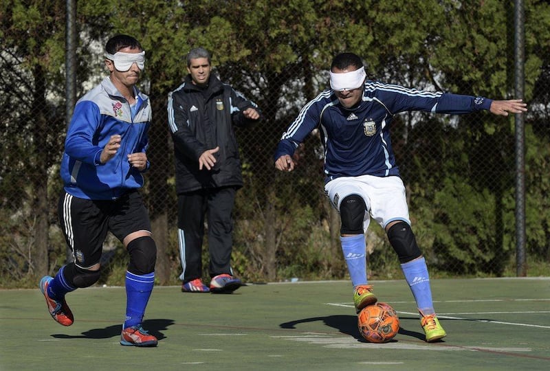 Silvio Velo, right, and Marcelo Panizza vie for the ball during a training session in Buenos Aires. Juan Mabromata / AFP