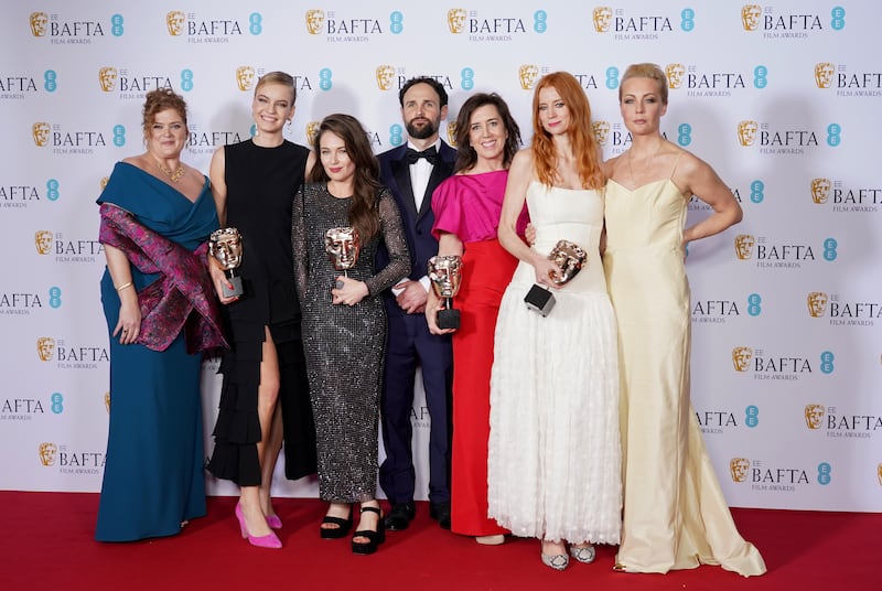 Navalny producers Melanie Miller, left, Shane Boris, centre, Diane Becker, third right, and Odessa Rae, second right, with the Baftas in London. Getty
