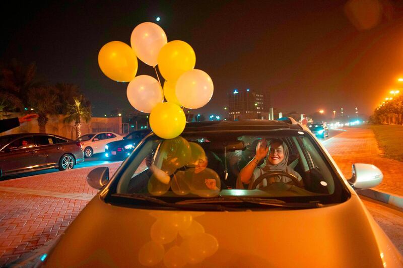 A Saudi woman and her friends celebrate her first time driving on a main street of Khobar City on her way to Kingdom of Bahrain on June 24, 2018. Saudi Arabia will allow women to drive from June 24, ending the world's only ban on female motorists, a historic reform marred by what rights groups call an expanding crackdown on activists. The move, which follows a sweeping crackdown on women activists who long opposed the ban, is part of Crown Prince Mohammed bin Salman's wide-ranging reform drive to modernise the conservative petrostate.

 / AFP / HUSSAIN RADWAN
