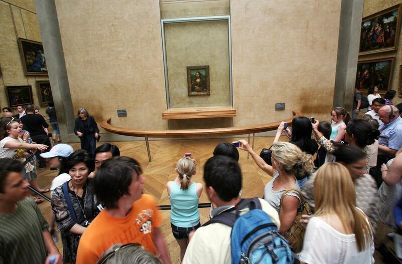 The Mona Lisa attracts a lot of visitors to the Louvre, many of whom just want to take a selfie with the painting. Loic Venance / AFP

