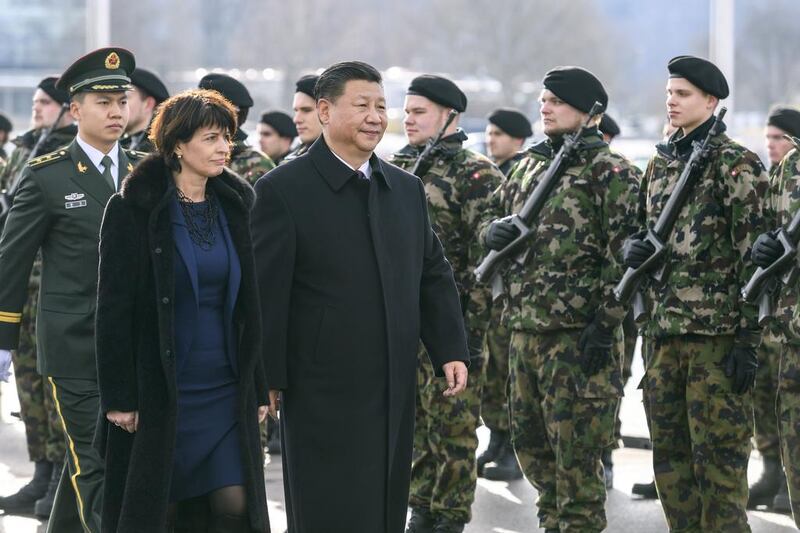 Chinese president Xi Jinping, centre, reviews the guard of honour next to Swiss president Doris Leuthard upon his arrival for a state visit. Mr Xi begins a two-day state visit to Switzerland before heading to Davos to address the World Economic Forum. Fabrice Coffrini / AFP