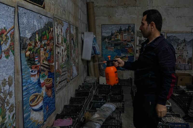 Mr Bakour sprays completed artworks with water to remove dust.