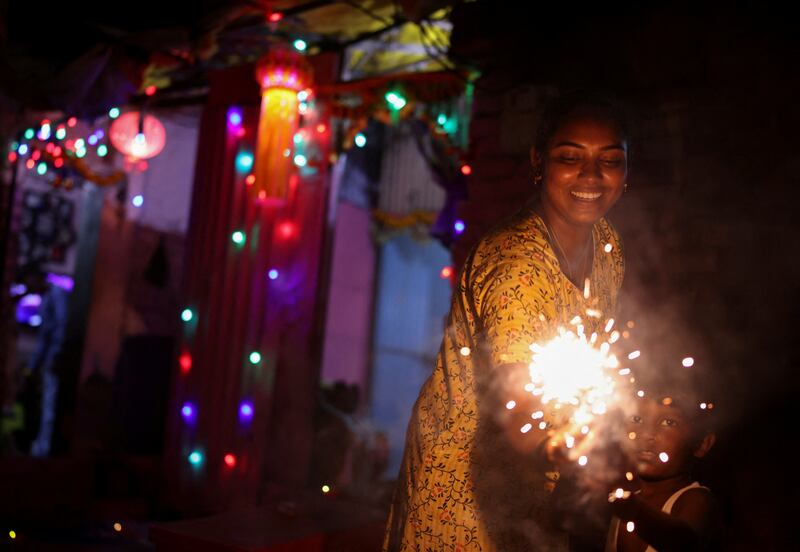 A woman and her son hold firecrackers during Diwali, the Hindu festival of lights, in Mumbai last year. Reuters