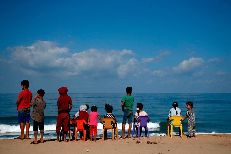 Palestinian children gather at the beach in Gaza City. AFP