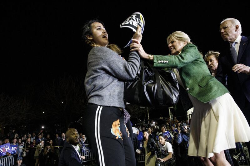 Former Vice President Joe Biden, 2020 Democratic presidential candidate, right, watches as his wife Jill Biden, center, blocks a protester from arriving on stage during an primary night rally in the Baldwin Hills neighborhood of Los Angeles, California, U.S. Bloomberg