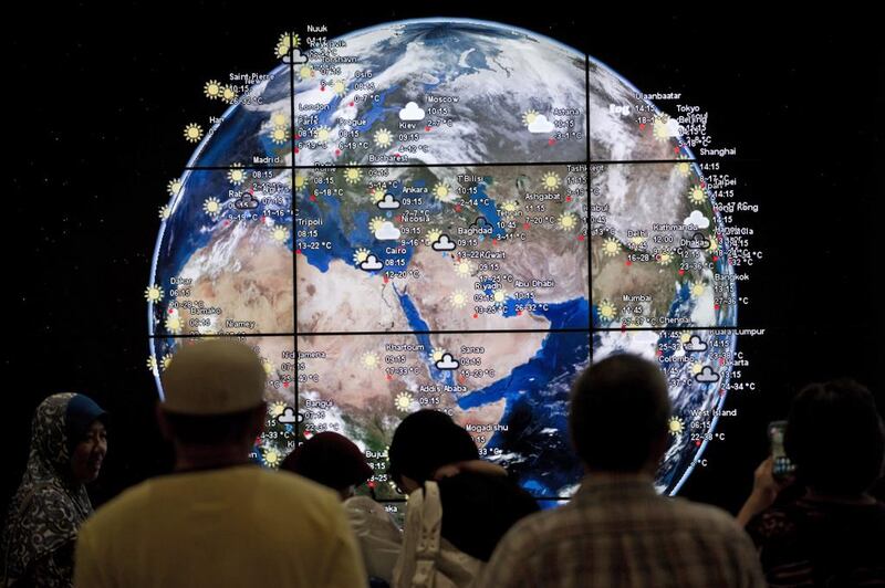 Passengers look at a “digital earth” displayed at Kuala Lumpur International Airport in Sepang, outside Kuala Lumpur. Mohd Rasfan / AFP 