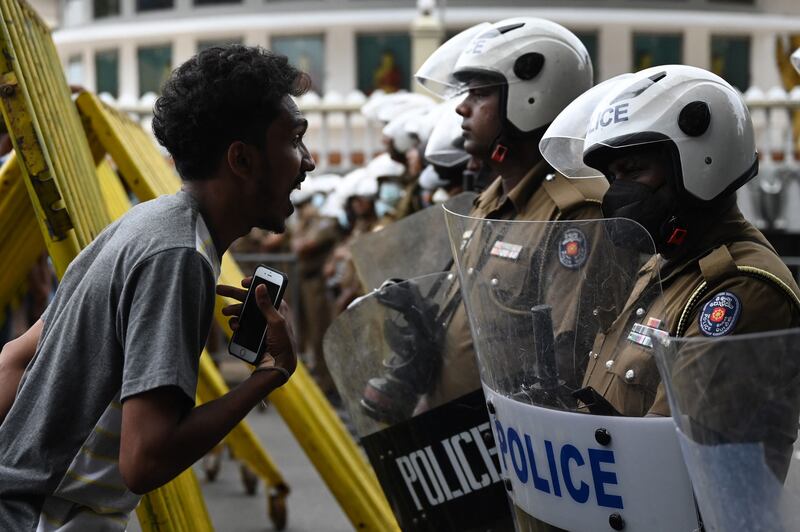 Demonstrators confront police during a march against Sri Lankan President Ranil Wickremesinghe in Colombo. AFP

