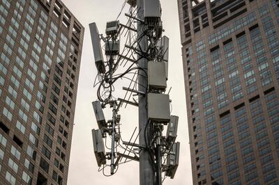 A cellphone tower, used for 5G network, is seen on a street in Beijing on April 7, 2020. / AFP / NICOLAS ASFOURI
