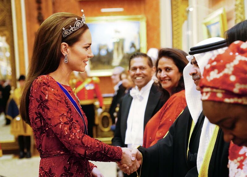 Kate speaks to guests at Buckingham Palace. Getty