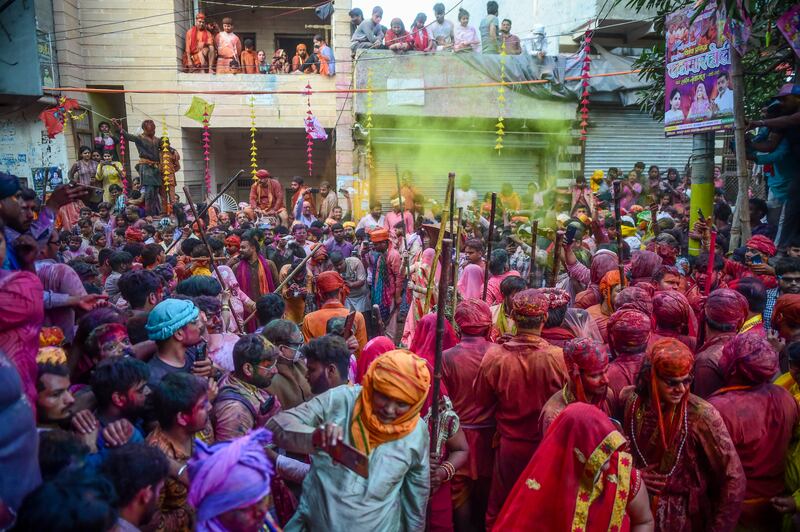 Women hit revellers with sticks during Lathmar Holi, part of the Hindu spring festival of colours, Holi, at the Radha Rani temple in Barsana, Uttar Pradesh, India. Getty Images