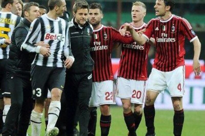 AC Milan's midfielder Mark Van Bommel, right, argues with Juventus defender Giorgio Chiellini, left, during the Serie A match.