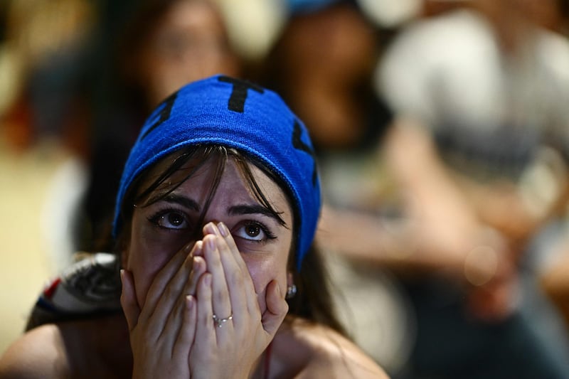 A supporter of Inter Milan reacts after InterMilan's defeat against Manchester City at the Piazza Castello (Castello's square) fanzone in Milan after the UEFA Champions League final. AFP