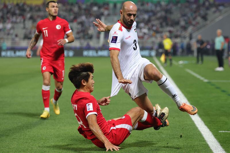 Hong Kong's Tan Chun Lok fights for the ball with Palestine's Mohammed Rashid during the Asian Cup group game. AFP